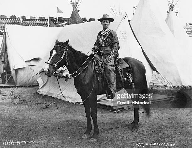 Portrait of Calamity Jane sitting on her horse. She was a frontierswoman who supposedly scouted for General Custer, and later travelled with Wild...