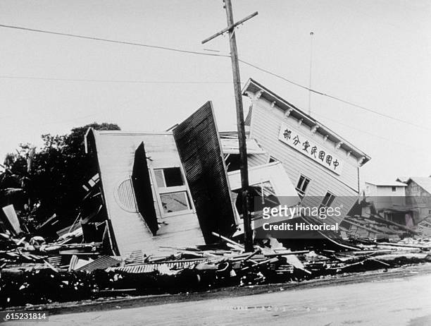 The wreckage of a political party clubhouse on Kamehameha Avenue, Hilo, Hawaii after the Tsunami generated by the 1946 Aleutian Islands earthquake of...