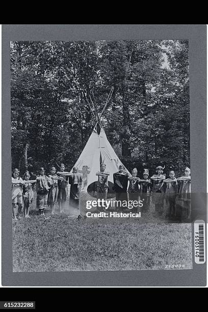 Few boys join a troop of Girl Scouts in a camp activity in which the children dress as Indians. Virginia, 1931. | Location: Camp May Flather, George...