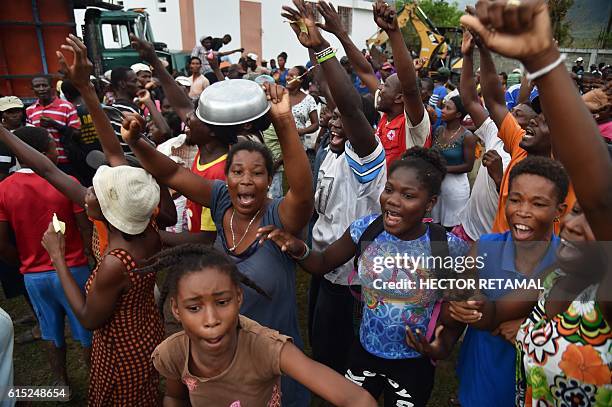 Hurricane Matthew victims protest against the quality of rice they have received during a food distribution from the UN's World Food Programme in the...