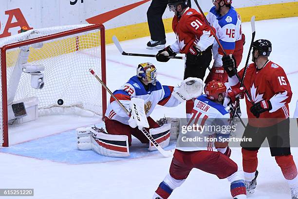 Team Russia Defenceman Alexei Emelin and Team Canada Forward Ryan Getzlaf hostile in front of the net as the puck gets by Team Russia Goalie Sergei...