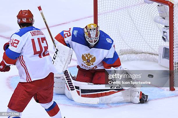 Team Russia Goalie Sergei Bobrovsky makes a save in front of Team Russia Forward Artem Anisimov during the WHOC semi final game between Team Russia...