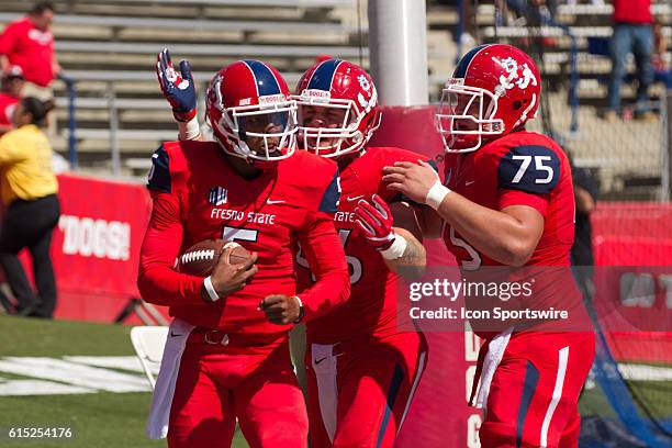 Fresno State Bulldogs quarterback Chason Virgil scores a touchdown and is meet by Fresno State Bulldogs offensive lineman Jacob Vazquez and Fresno...