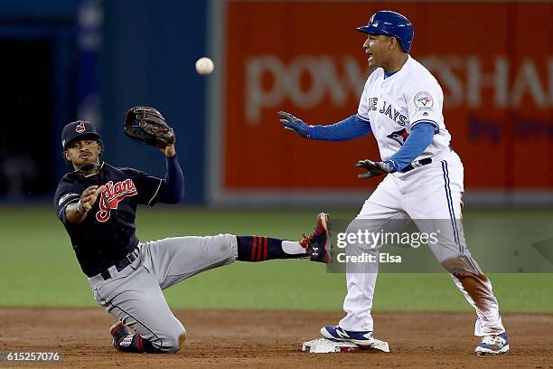 Francisco Lindor of the Cleveland Indians turns a double play tagging out Ezequiel Carrera of the Toronto Blue Jays at second base to end the second...