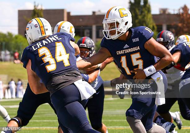 Chattanooga Mocs quarterback Alejandro Bennifield hands the ball off to Chattanooga Mocs running back Derrick Craine during the game between Samford...