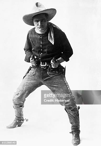 Cowboy star Tom Mix poses with his pistols. Mix and his horse, Tony, were the heroes of silver-screen westerns during the silent era.