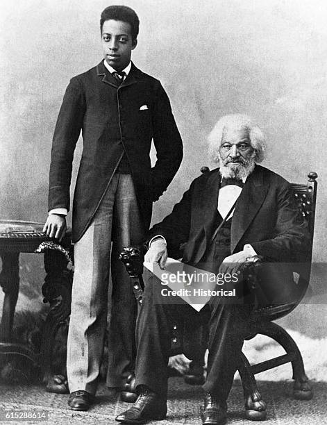 Frederick Douglass, seated, poses with his grandson Joseph. Douglass, an escaped slave, educated himself and was one of the foremost writers and...