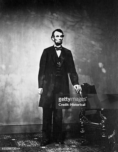 Abraham Lincoln , 16th president of the United States, stands next to a chair. Lincoln declared the Emancipation Proclamation in 1863, freeing all...
