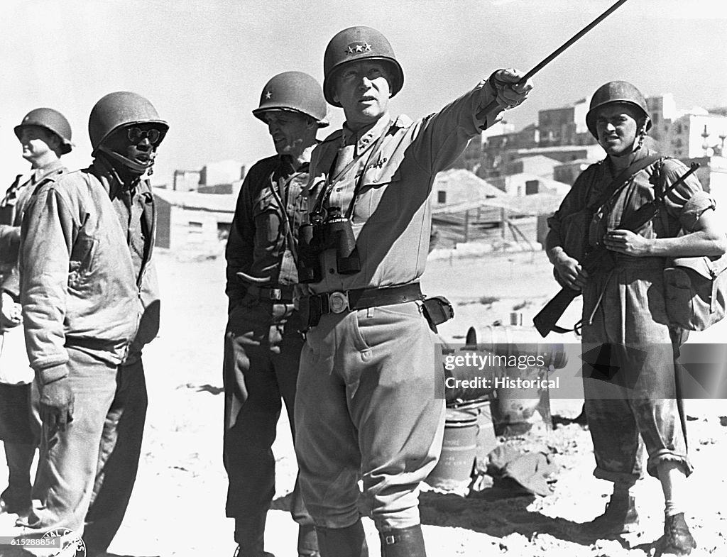 General George S. Patton directs American troops in 1944. He played a ...