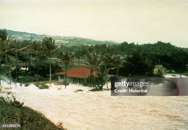 Tsunami generated thousands of miles away in the Aleutian Islands washes over Laie Point on Oahu.