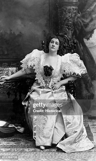 Emma Eames sits in a chair and wears a lace-trimmed dress. Eames was a popular opera singer, performing with the Paris Opera and the Metropolitan...