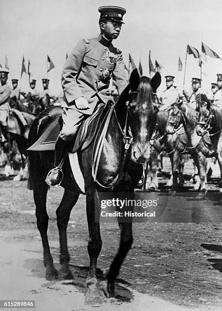 Young Hirohito , Emperor of Japan, inspects soldiers on horseback.