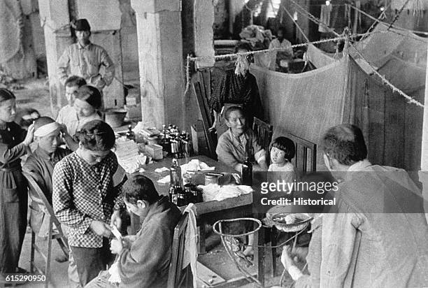 Workers treat patients at the Fukuromachi Relief Station who have been exposed to the radiation from the atomic bombs dropped on Japan in August 1945...