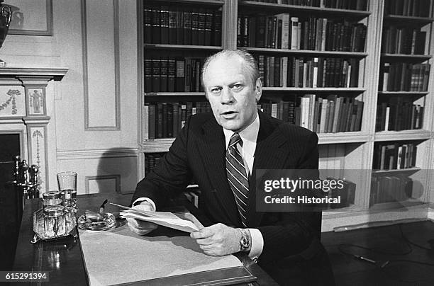 Gerald Ford sits at a desk. Ford, 38th president of the United States, was the successor to Richard Nixon, and the only president who was not elected...