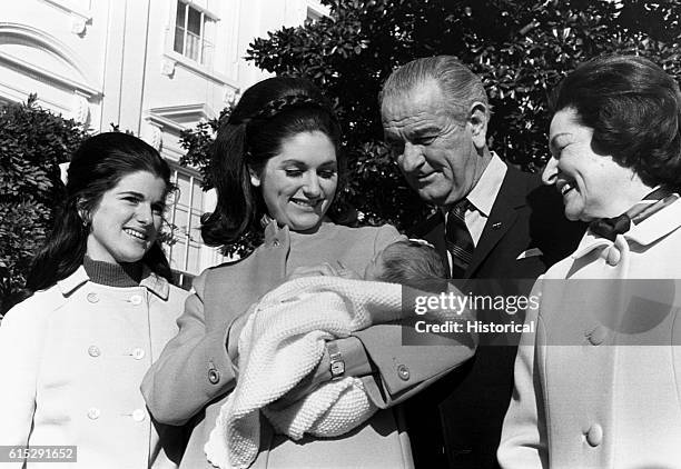 The 36th President of the United States, Lyndon Baines Johnson stands with First Lady, Claudia Alta "Lady Bird" Taylor Johnson, and their daughters...