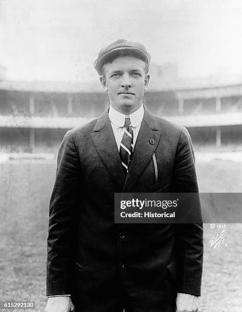 Christy Mathewson stands in a baseball stadium. Mathewson was an American baseball player.