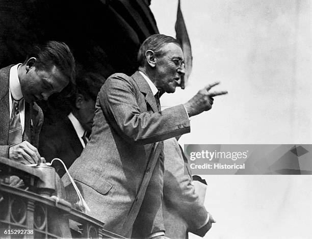 President Woodrow Wilson delivers a speech from the back of a train.