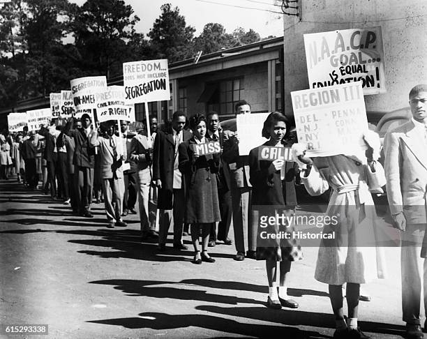 Line of African Americans hailing from states across the USA march to protest segregation. Ca. 1950.