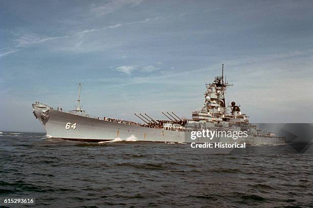 The battleship USS Wisconsin with sailors manning the rails as the vessel returns to port from deployment in the Persian Gulf area during Operation...