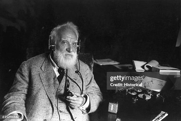 American inventor Alexander Graham Bell with one of his inventions, ca. 1910. Bell engineered the first intelligible electronic transmission of voice...