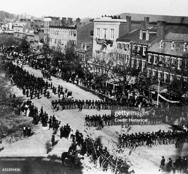 The funeral procession for President Abraham Lincoln passes down a city street in April of 1865.