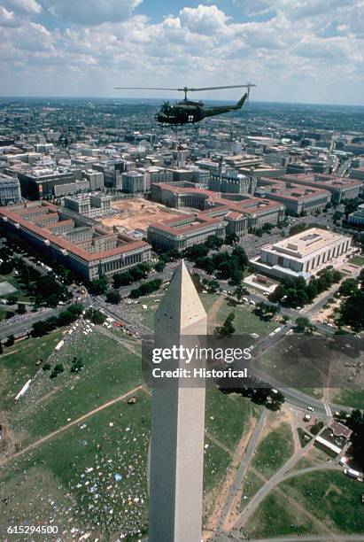 Iroquois helicopter flies over the Washington Monument as it arrives to take part in the National Victory Celebration. The parade is being held in...