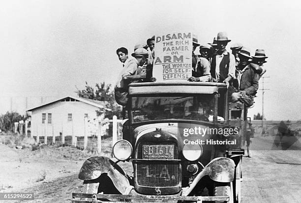 Group of Mexican farm workers protest from the back of a truck during a strike in California in 1933.