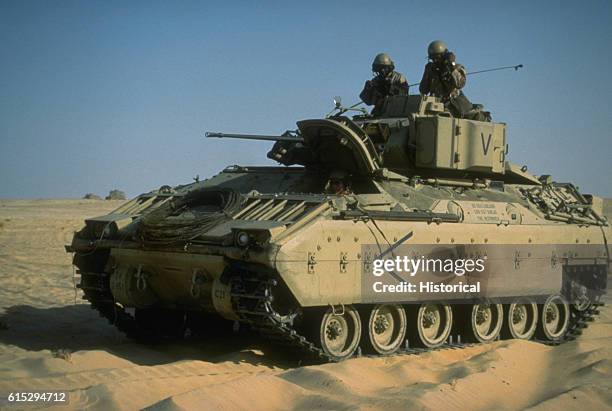 An M-2 Bradley infantry fighting vehicle of the 24th Infantry Division arrives at an encampment during Operation Desert Shield. Saudi Arabia,...