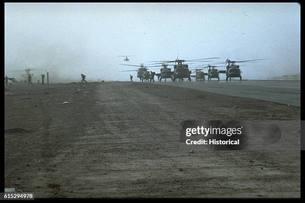 Formation of UH-60 Black Hawk helicopters land at Point Salinas airfield during the multi-services, multinational Operation Urgent Fury. A AH-1 Sea...