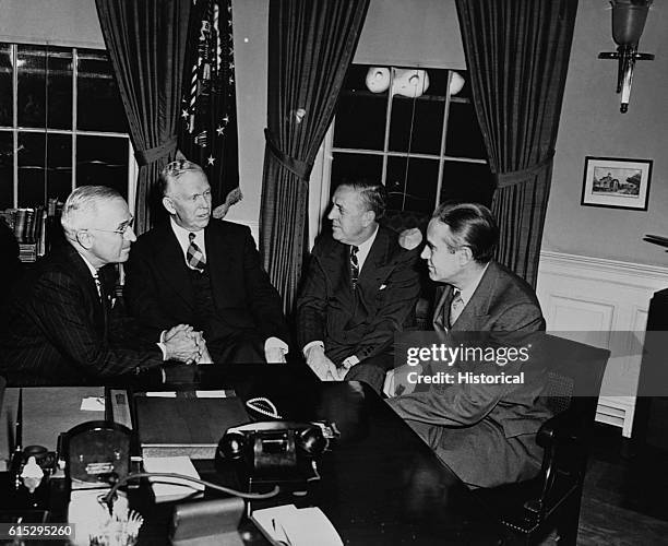 President Harry Truman meets with George Marshall, Economic Cooperation Administration chief Paul Hoffman, and ECA roving ambassador W. Averell...