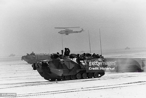 Amphibious assault vehicles of the 1st Combat Engineer Battalion , 1st Marine Division, advance toward Kuwait City during the third day of the ground...