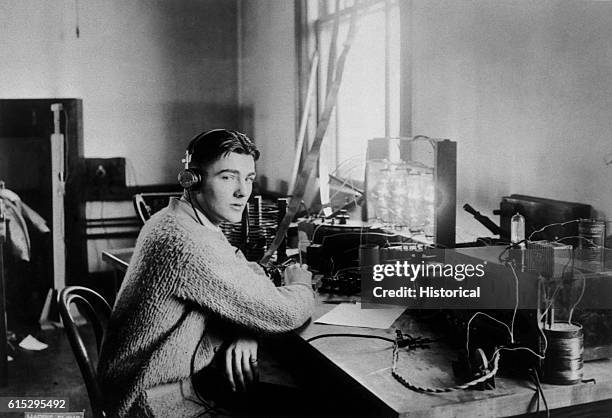 Herbert Hoover, Jr., at a radio set, who later made the national broadcast of the Zeppelin's flight over Los Angeles.