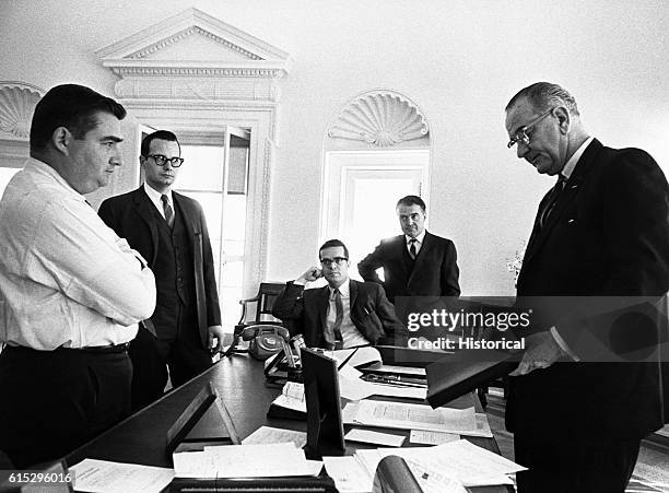 President Johnson's aides gathered in his office for a briefing: Left to right, Pierre Salinger, Bill Moyers, Ted Sorensen, Jack Valent.