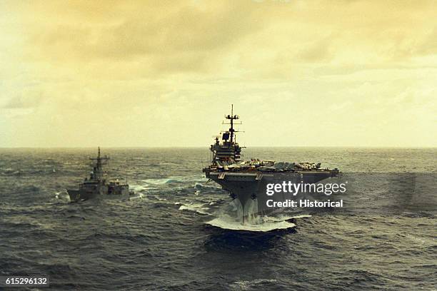 The aircraft carrier USS Saratoga underway in heavy seas while en route to the Mediterranean Sea. The guided missile frigate USS Samuel Eliot Morison...