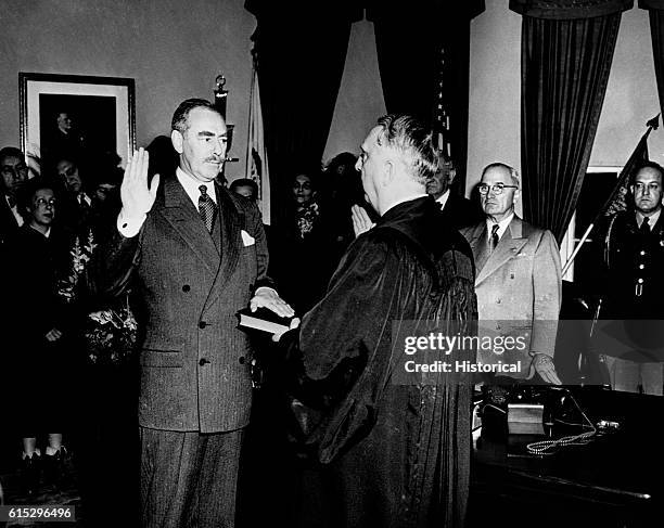 Chief Justice Fred Vinson swears in Dean Acheson as Secretary of State before President Truman.