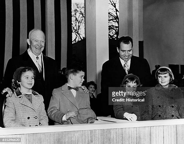 President Dwight Eisenhower and Vice President Richard Nixon greet the public on their second Inauguration Day, Eisenhower with his grandchildren...