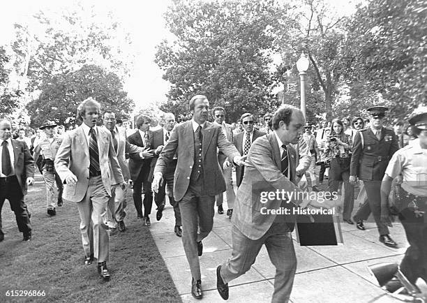Police and secret service officers run to protect President Gerald Ford during an attempt at assassination by Lynette "Squeaky" Fromme. September 5,...