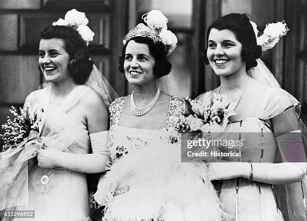 Kathleen, Rose, and Rosemary Kennedy, in formal gowns and carrying bouquets for their presentation at Buckingham Palace, May 11, 1938.