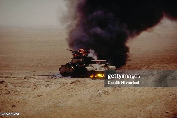 An Iraqi T-55 main battle tank burns after an attack by the 1st United Kingdom Armored Division during Operation Desert Storm.