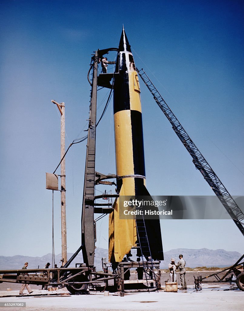 V.2 Several men work on testing a V-2 missile in the late 1940s. The ...