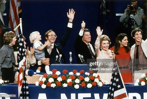 Ronald Reagan gives the thumbs-up signal at the 1980 Republican National Convention in Detroit. With him are daughter Maureen , son Michael , son...