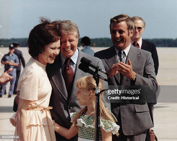 President Jimmy Carter, Vice President Walter Mondale, and Amy Carter greet First Lady Rosalynn Carter on her return June 3, 1977.