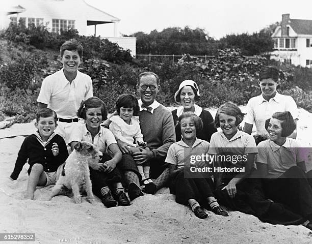 Joseph P. And Rose Kennedy pose for a picture on the beach at Hyannis Port, Massachusetts with their eight children.