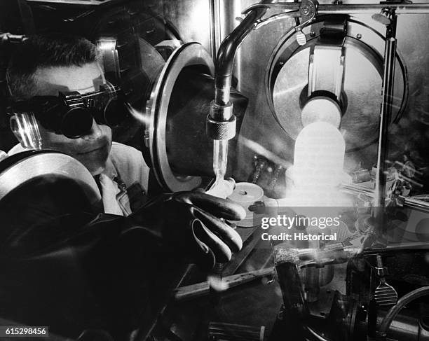 Researchers test a plutonium alloy sample made from nuclear reactor fuels from a Breeder Reactor. Component metals for a reactor fuel alloy are...