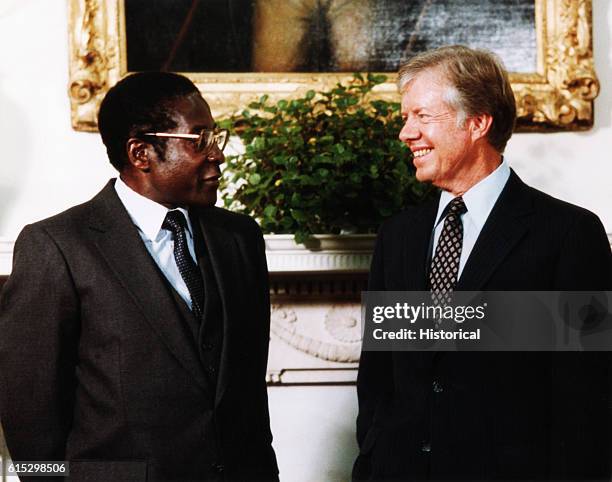 President Jimmy Carter meets with Robert Mugabe, prime minister of the newly independent Zimbabwe . August 27, 1980.