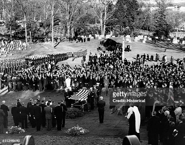 Mourners gathered at Arlington National Cemetery for the burial ceremony for assassinated president John F. Kennedy.