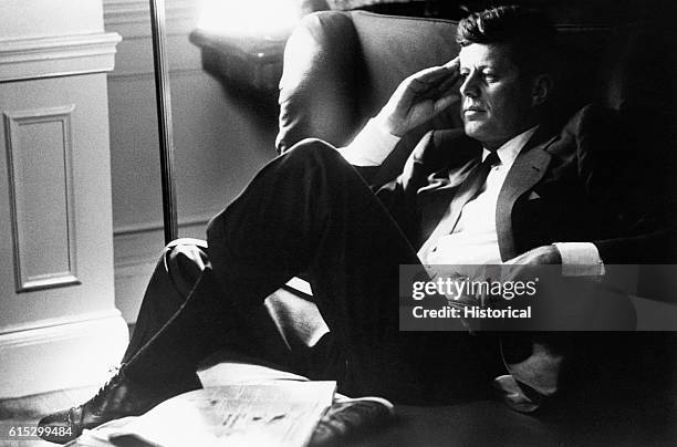 Presidential candidate John F. Kennedy relaxes in his Boston apartment.