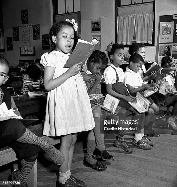 Young African American children attending a reading lesson in a segregated elementary school. Washington, DC, March 1942.