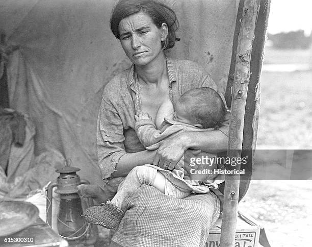 Migrant agricultural worker's wife and child in a camp. Nipomo, California, March 1936.