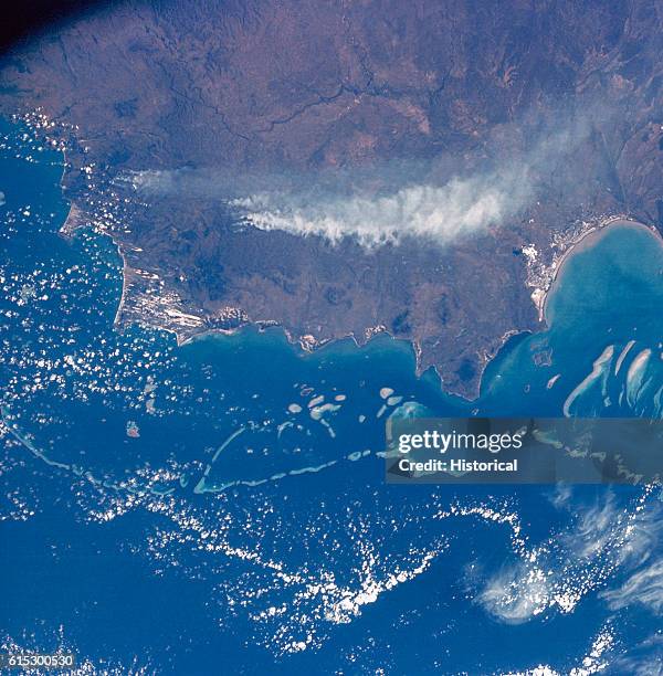 The Great Barrier Reef, Cape Melville, and Cape Flattery, of Queensland, Australia, as seen by Apollo 7 from space. A trail of smoke from forest...